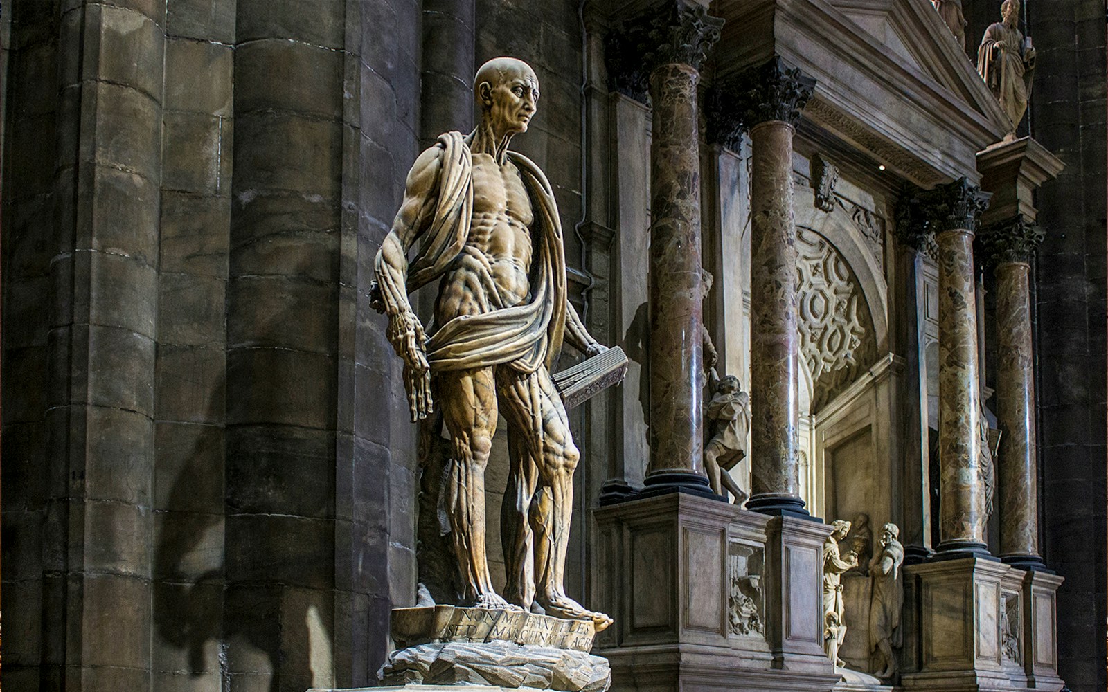 Statue of St. Bartholomew Flayed Alive inside Duomo Milan Cathedral, Italy.