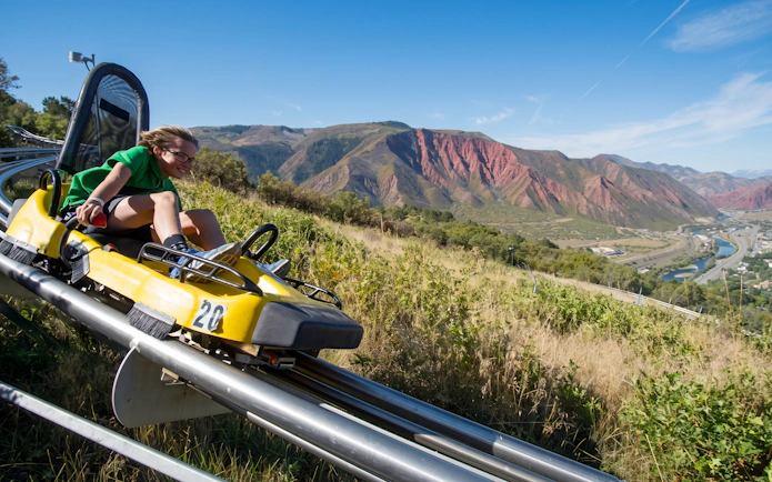 Alpine Coaster ride at Glenwood Caverns Adventure Park with mountain view.