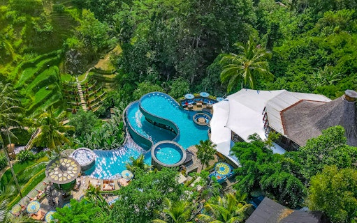 Aerial view of tiered pool at Cretya Spa, surrounded by lush greenery, Alas Harum Bali.