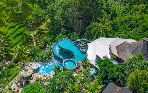 Aerial view of tiered pool at Cretya Spa, surrounded by lush greenery, Alas Harum Bali.