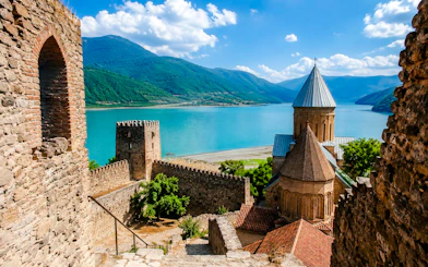 Gergeti Trinity Church with mountain and lake view in Kazbegi, Georgia.