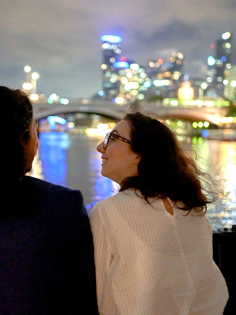 Couple enjoying Melbourne city lights on a dinner cruise.