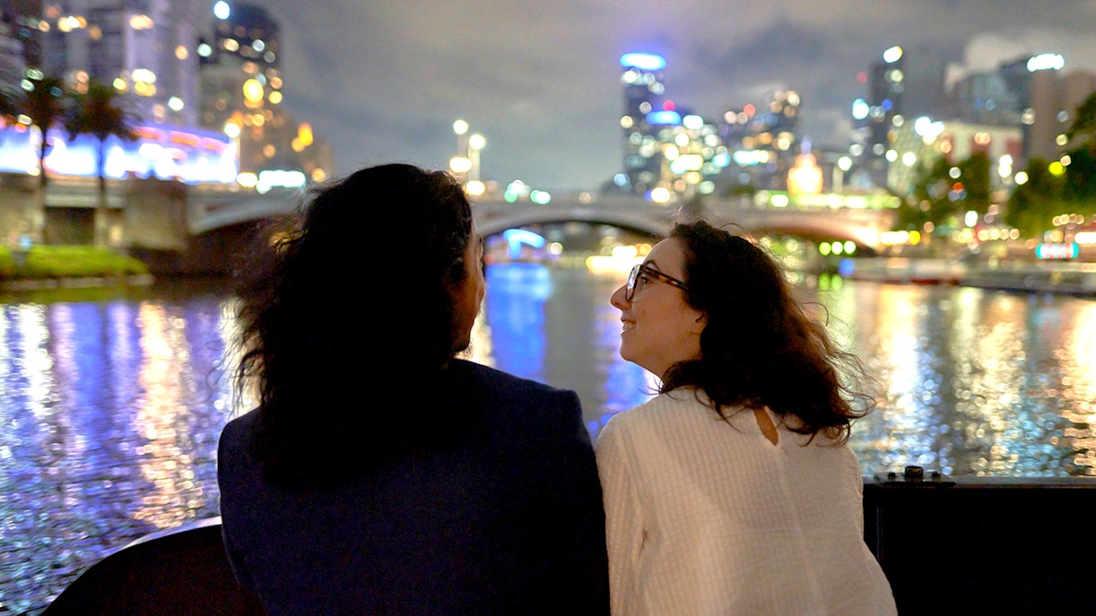 Couple enjoying Melbourne city lights on a dinner cruise.