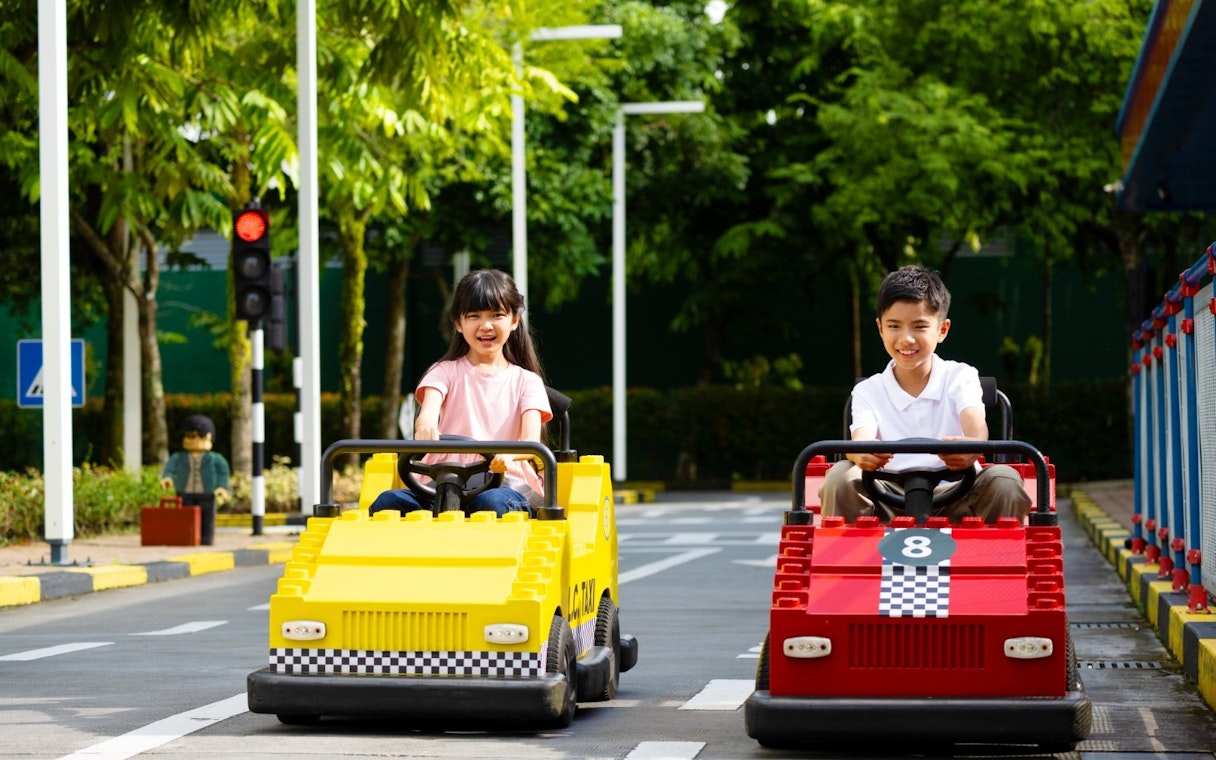 Children driving go-karts at Legoland Malaysia.