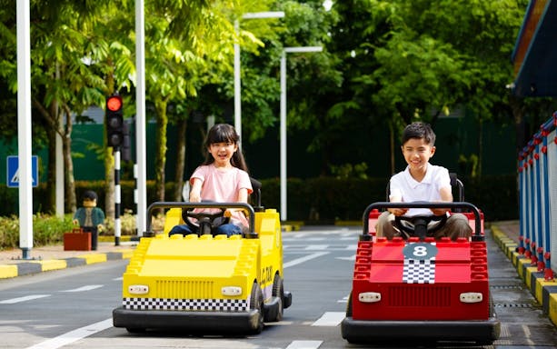 Children driving go-karts at Legoland Malaysia.