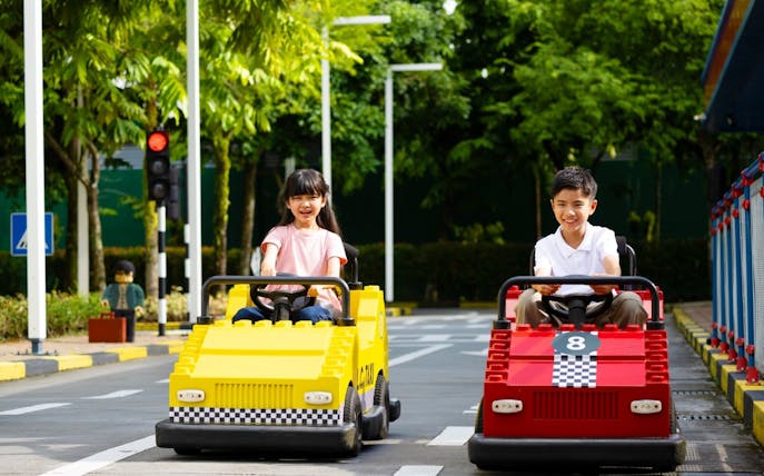 Children driving go-karts at Legoland Malaysia.