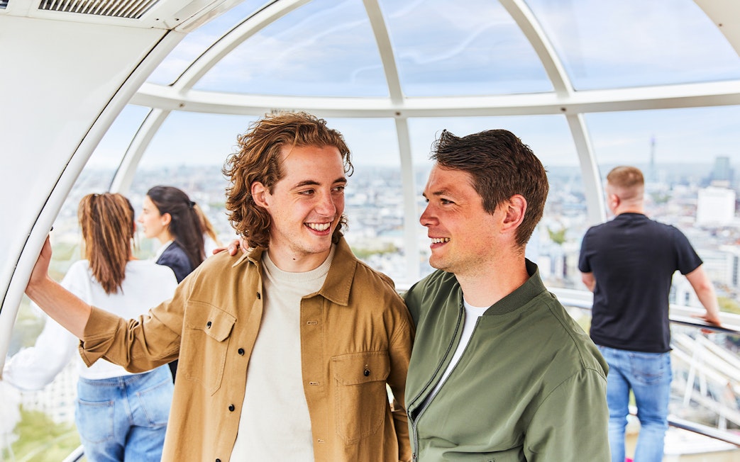 People enjoying the view from a London Eye capsule.