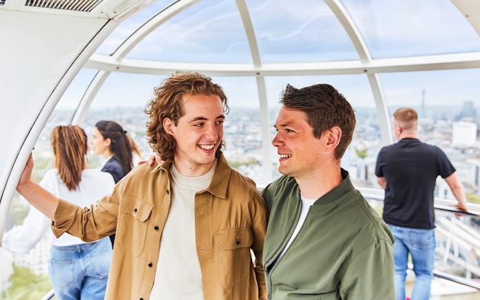People enjoying the view from a London Eye capsule.
