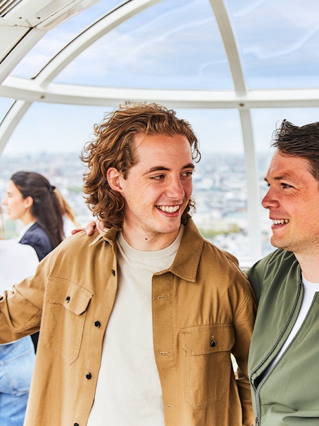 People enjoying the view from a London Eye capsule.