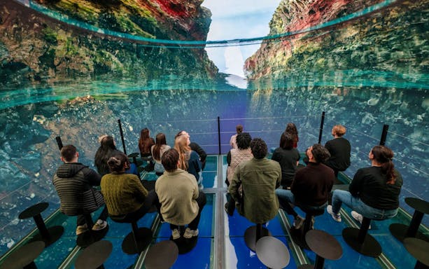 Guests viewing a virtual ocean display inside Perlan Museum, Reykjavik.