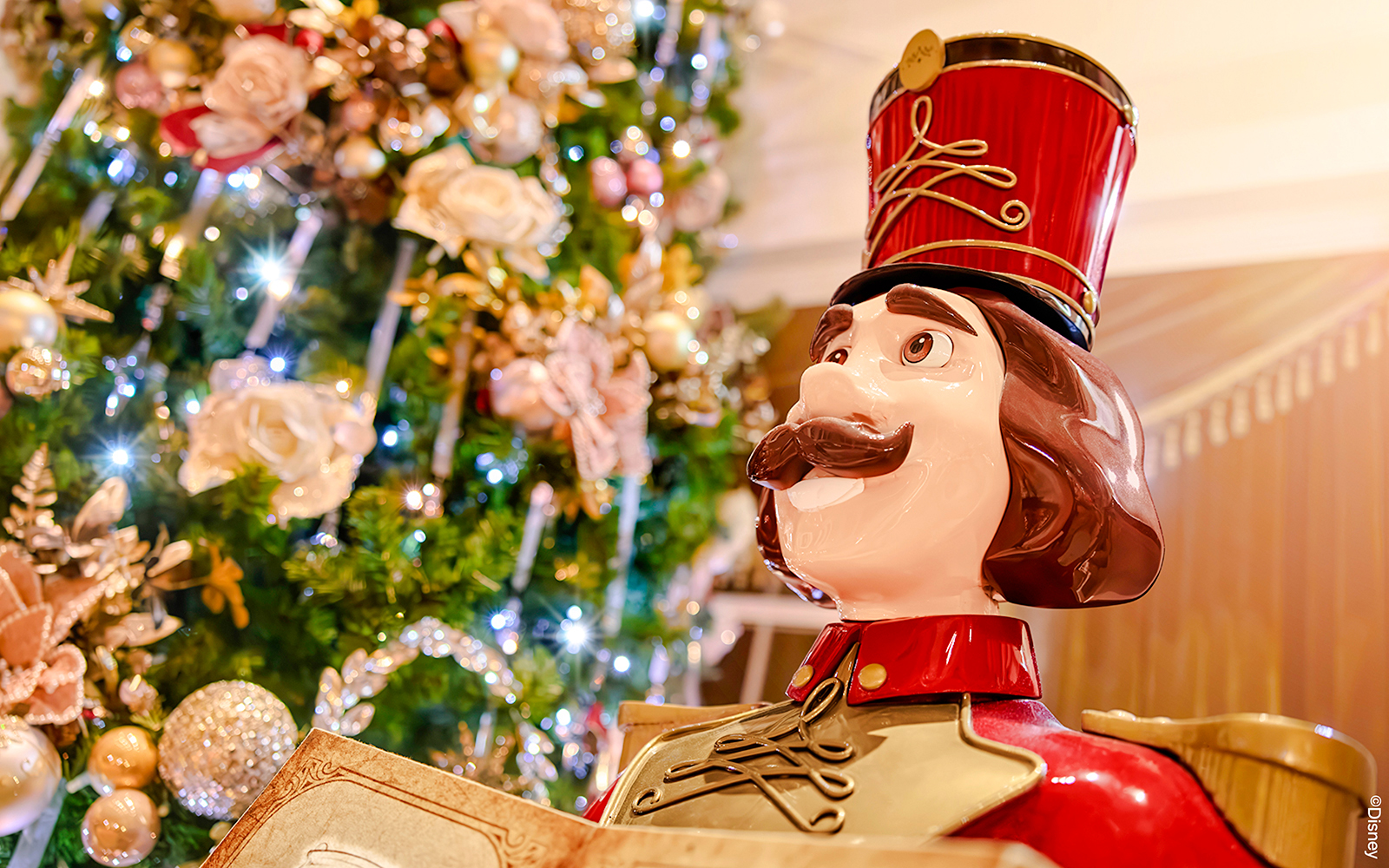 Nutcracker statue in front of a decorated Christmas tree at Disneyland Paris 2025.