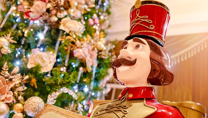 Nutcracker statue in front of a decorated Christmas tree at Disneyland Paris 2025.