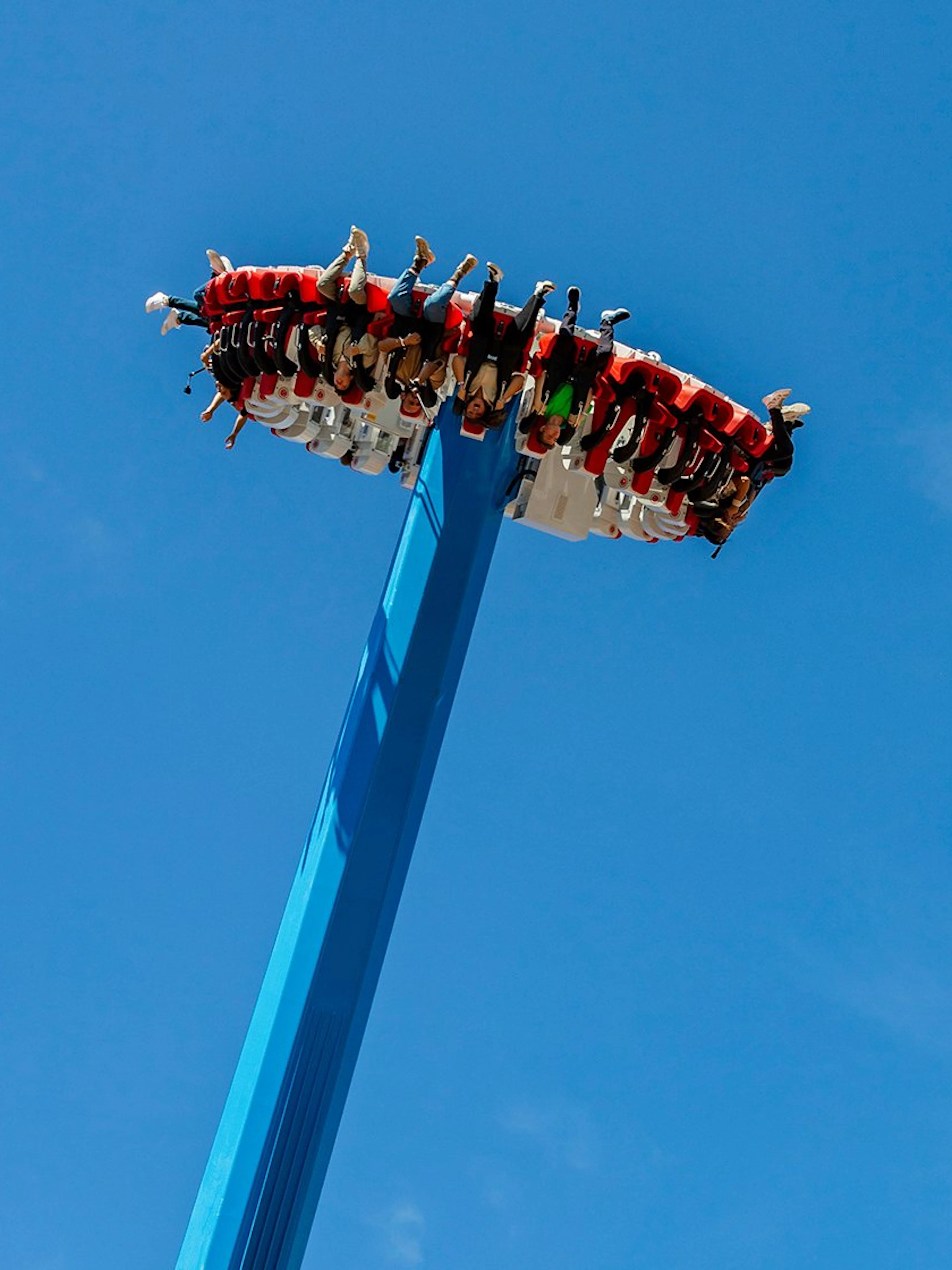 Visitors on a high-thrill ride at Vialand Theme Park, Istanbul against a clear blue sky.