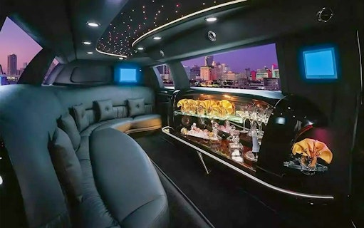 Luxurious limousine interior with bar and city view, Dubai private rental service.