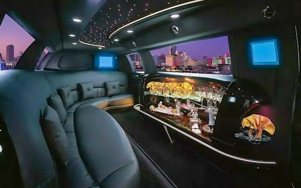 Luxurious limousine interior with bar and city view, Dubai private rental service.