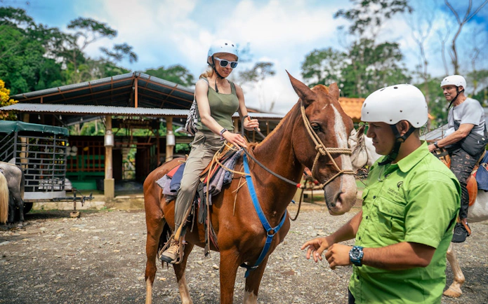 Horseback riding tour participants preparing in Manuel Antonio jungle.