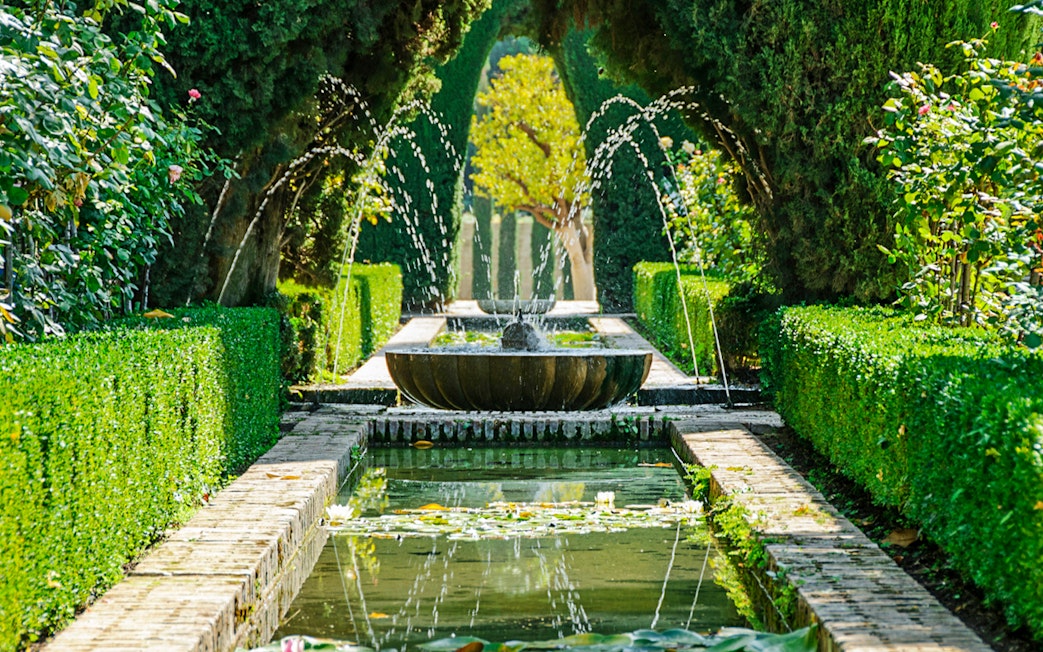 Fountain and garden path in Alhambra, Granada, Spain.