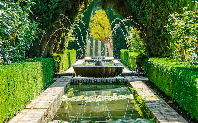 Fountain and garden path in Alhambra, Granada, Spain.