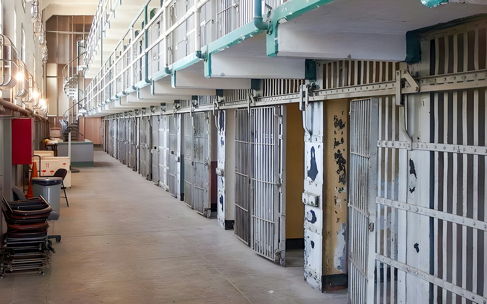 Prison cells on Alcatraz Island, San Francisco, with open barred doors and a walkway.