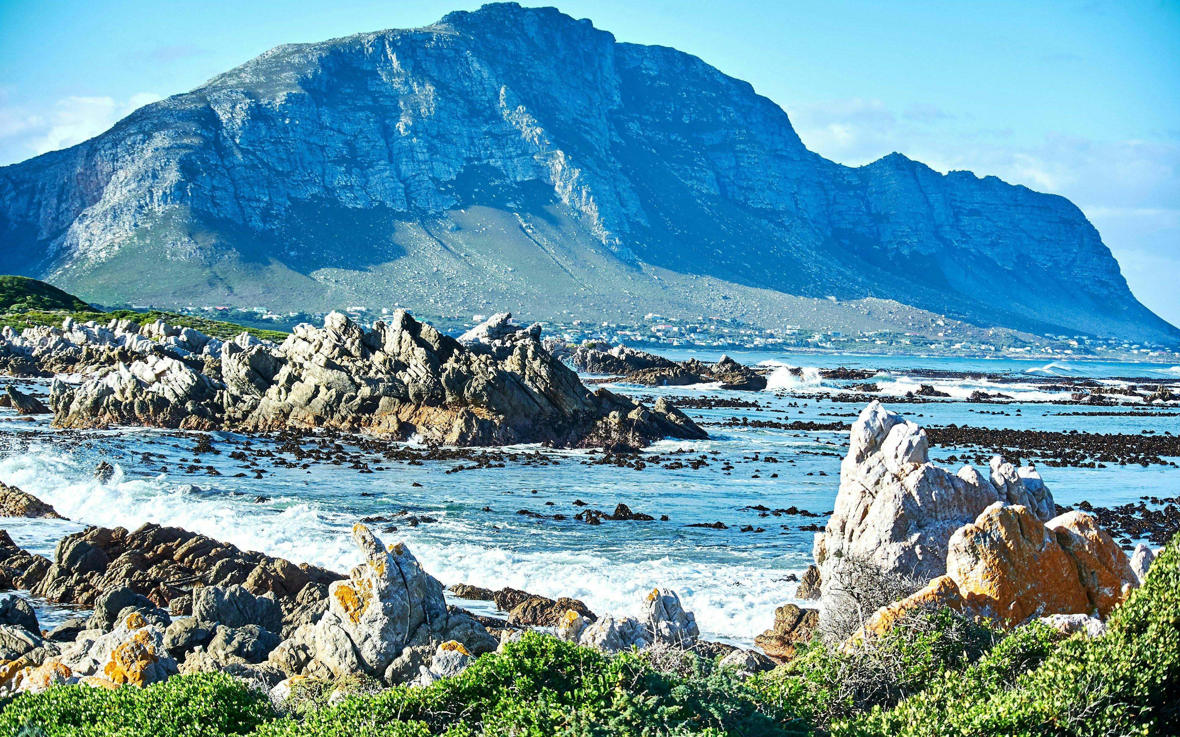 Rocky coastline at Stony Point Nature Reserve, Betty's Bay, with Boland Mountain Complex in the background.