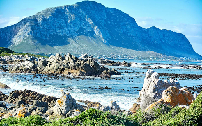 Rocky coastline at Stony Point Nature Reserve, Betty's Bay, with Boland Mountain Complex in the background.