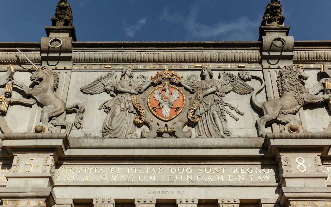 Gdansk Golden Gate facade with intricate sculptures and Polish coat of arms.