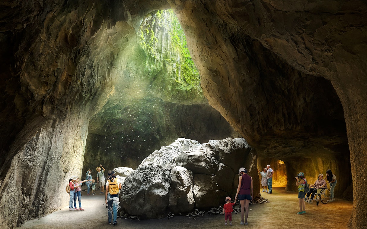 Visitors exploring a sunlit cave in Rainforest Wild Asia.