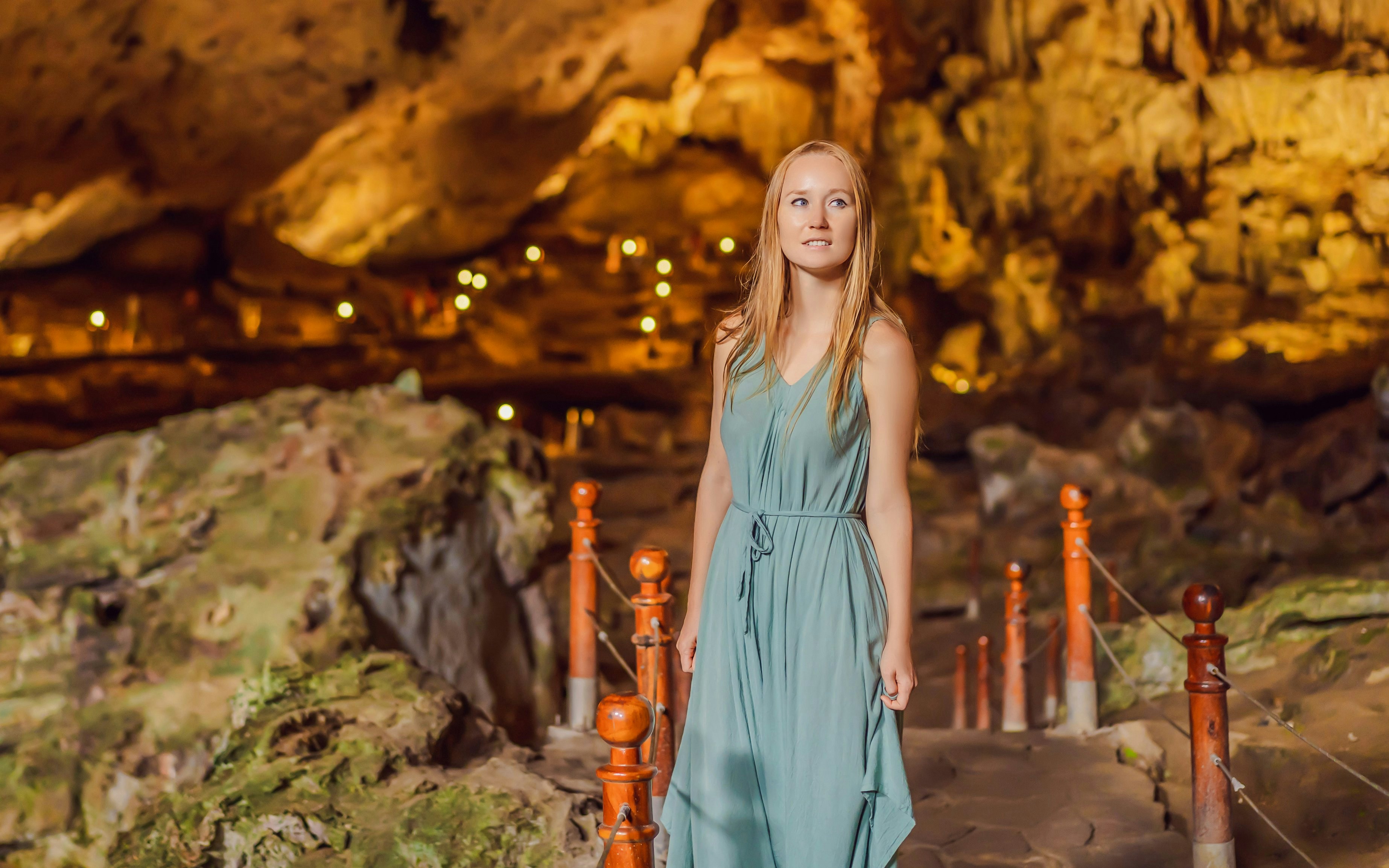 Woman exploring Sung Sot cave in Ha Long Bay, Vietnam.