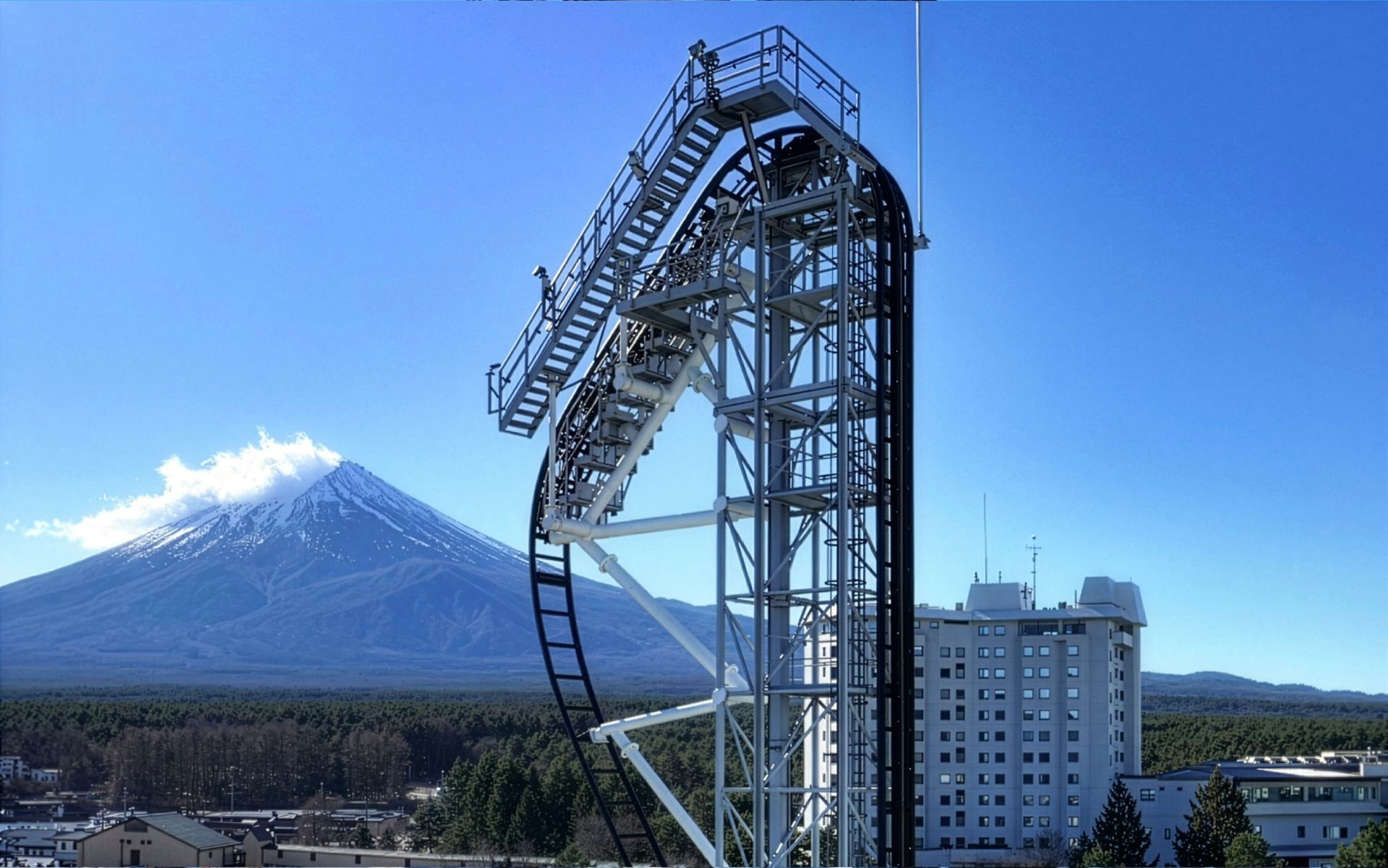 Roller coaster at Fuji-Q Highland Amusement Park with Mount Fuji in the background.