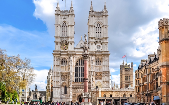 Westminster Abbey facade with towers and clock, London.