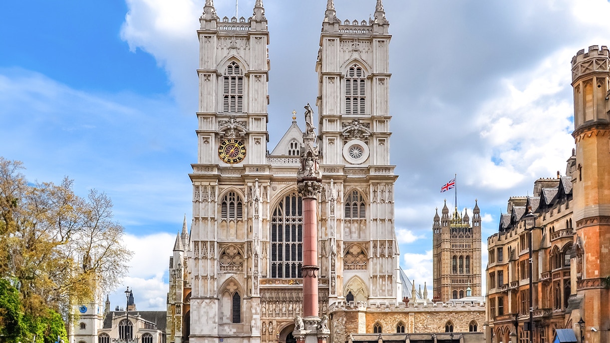 Westminster Abbey facade with towers and clock, London.