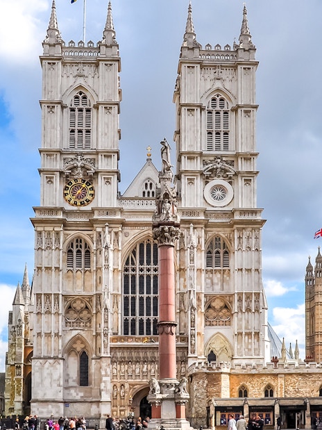 Westminster Abbey facade with towers and clock, London.