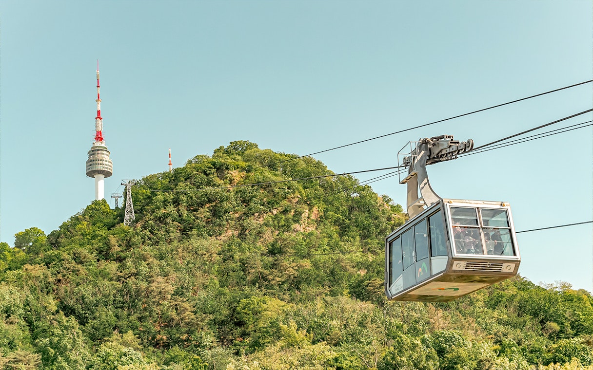 Cable car ascending with Namsan Tower in the background, Seoul, South Korea.