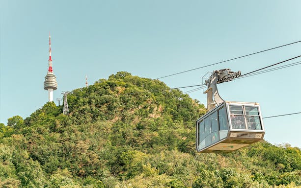 Cable car ascending with Namsan Tower in the background, Seoul, South Korea.