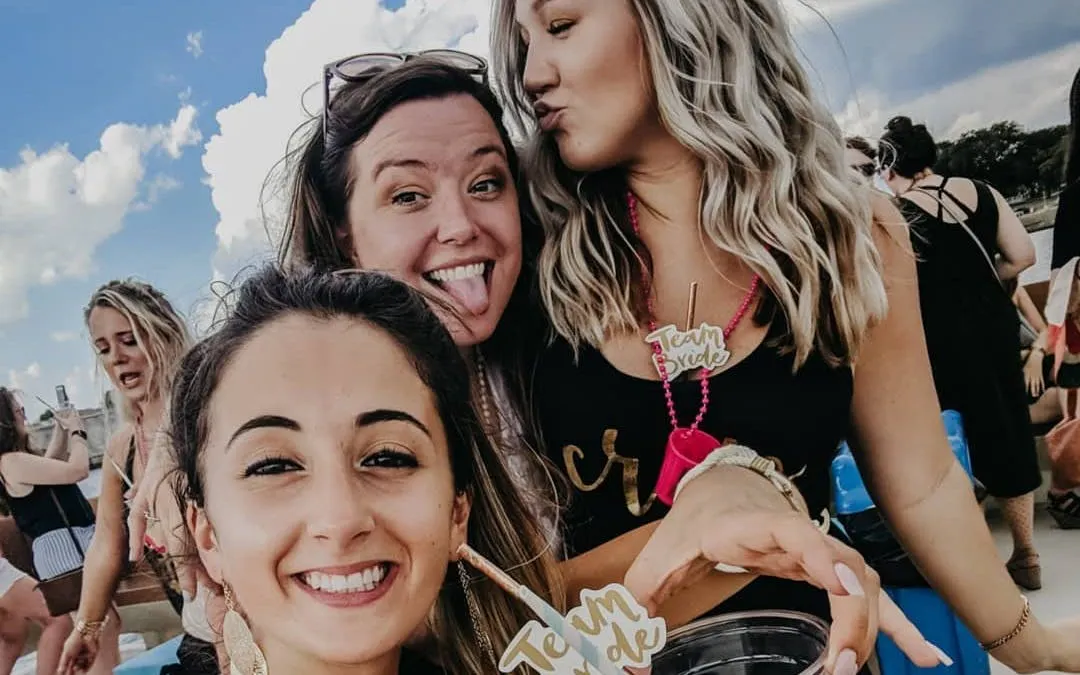 Partygoers enjoying a Washington, DC yacht cruise with open bar and city views.