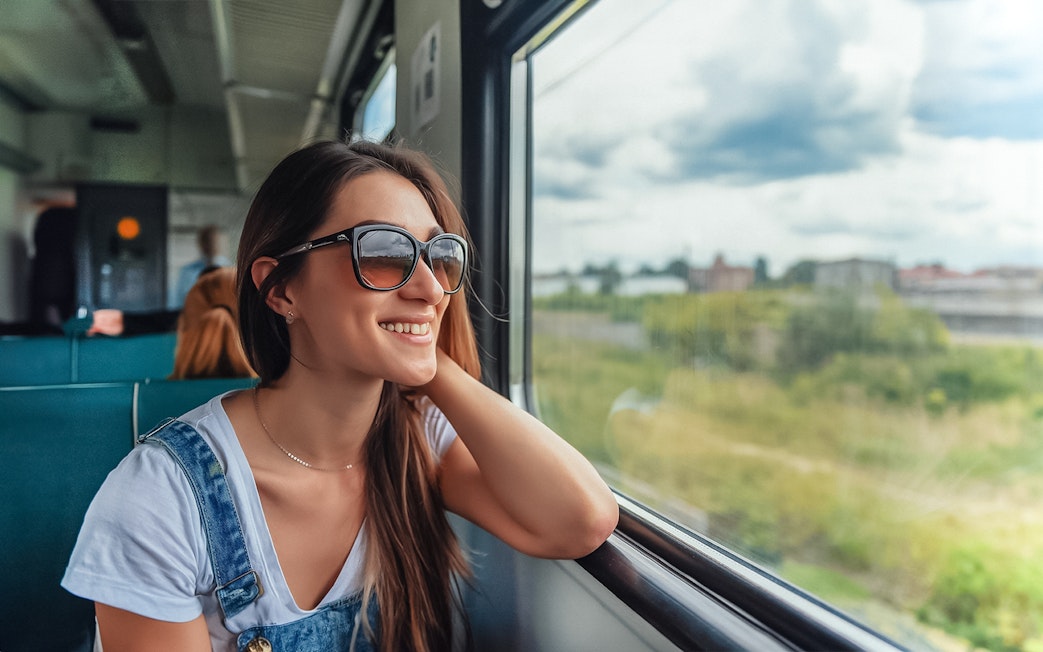 Traveler enjoying scenic view on Naples train tour.