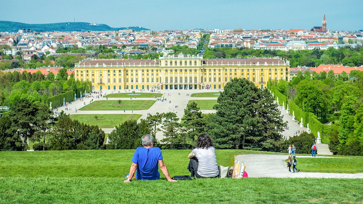Schonbrunn Palace gardens with visitors in Vienna, Austria.