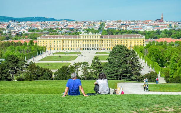 Schonbrunn Palace gardens with visitors in Vienna, Austria.