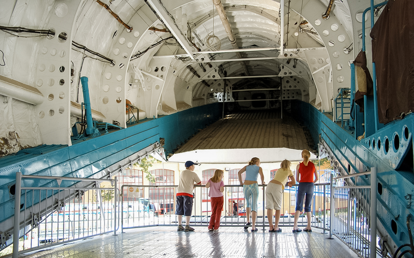 Visitors inside a large aircraft exhibit at Technik Museum Speyer.