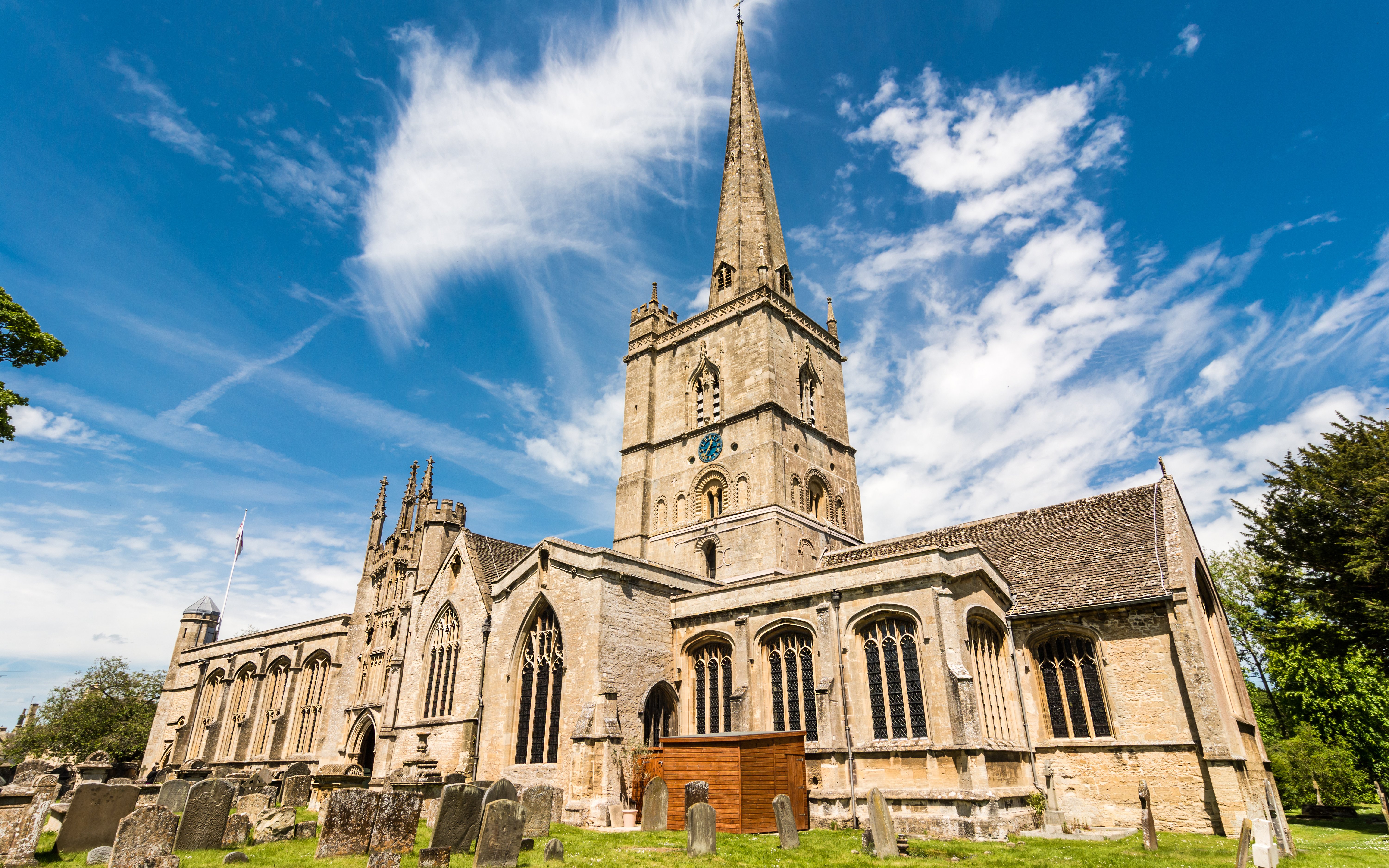 St John the Baptist Church in Burford with its tall spire and historic architecture.