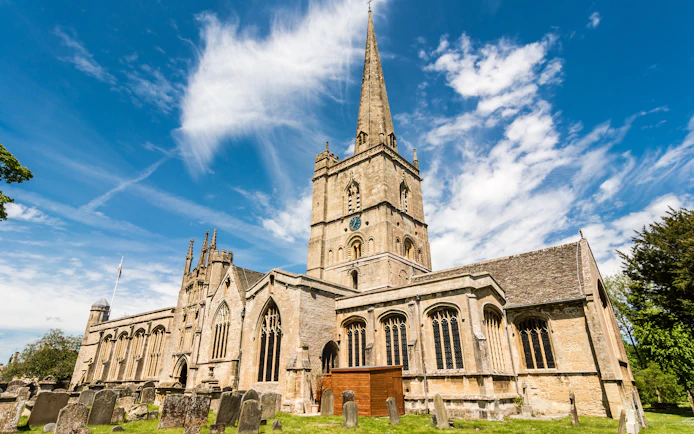 St John the Baptist Church in Burford with its tall spire and historic architecture.