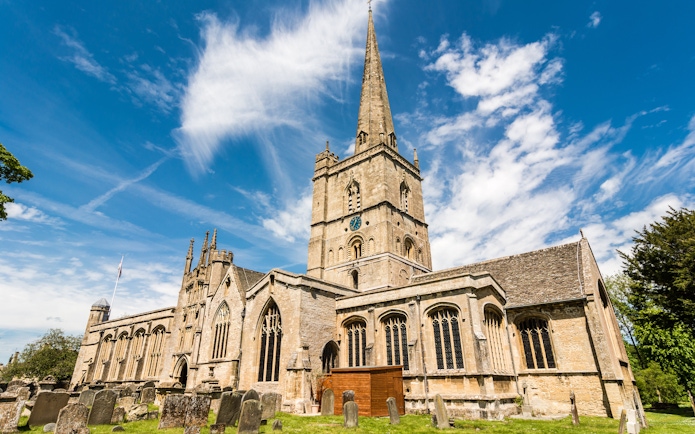St John the Baptist Church in Burford with its tall spire and historic architecture.