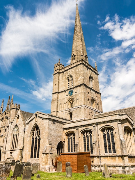 St John the Baptist Church in Burford with its tall spire and historic architecture.