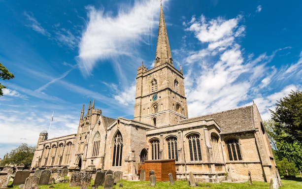St John the Baptist Church in Burford with its tall spire and historic architecture.