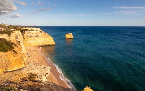 Algarve coastline with cliffs and beach, part of guided tour of landscapes and winery.