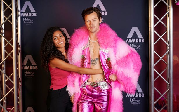 Visitor posing with wax figure at Madame Tussauds Berlin.