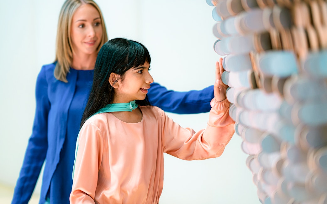 Visitors interacting with a tactile exhibit at the Museum of the Future in Dubai.