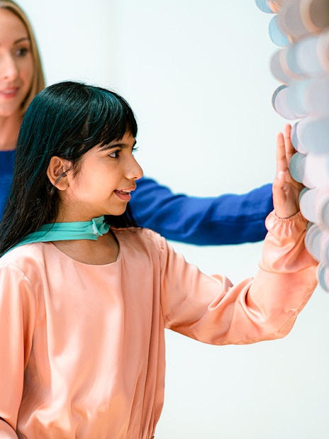 Visitors interacting with a tactile exhibit at the Museum of the Future in Dubai.