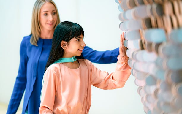 Visitors interacting with a tactile exhibit at the Museum of the Future in Dubai.