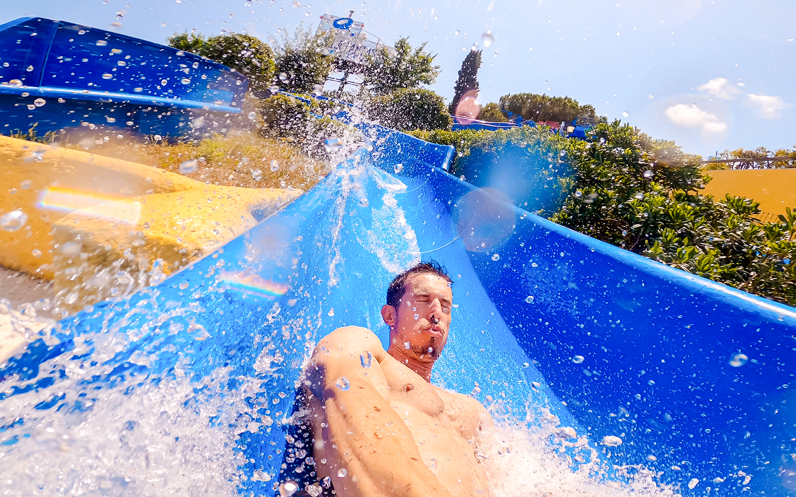 Man enjoying a water slide at Marineland Antibes, Nice, France.